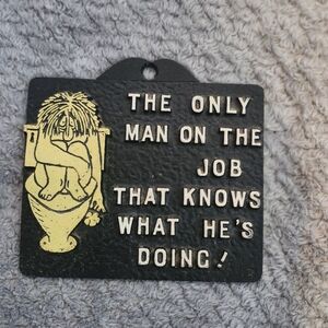 Vintage Cast Iron Trivet " The Only Man On The Job"